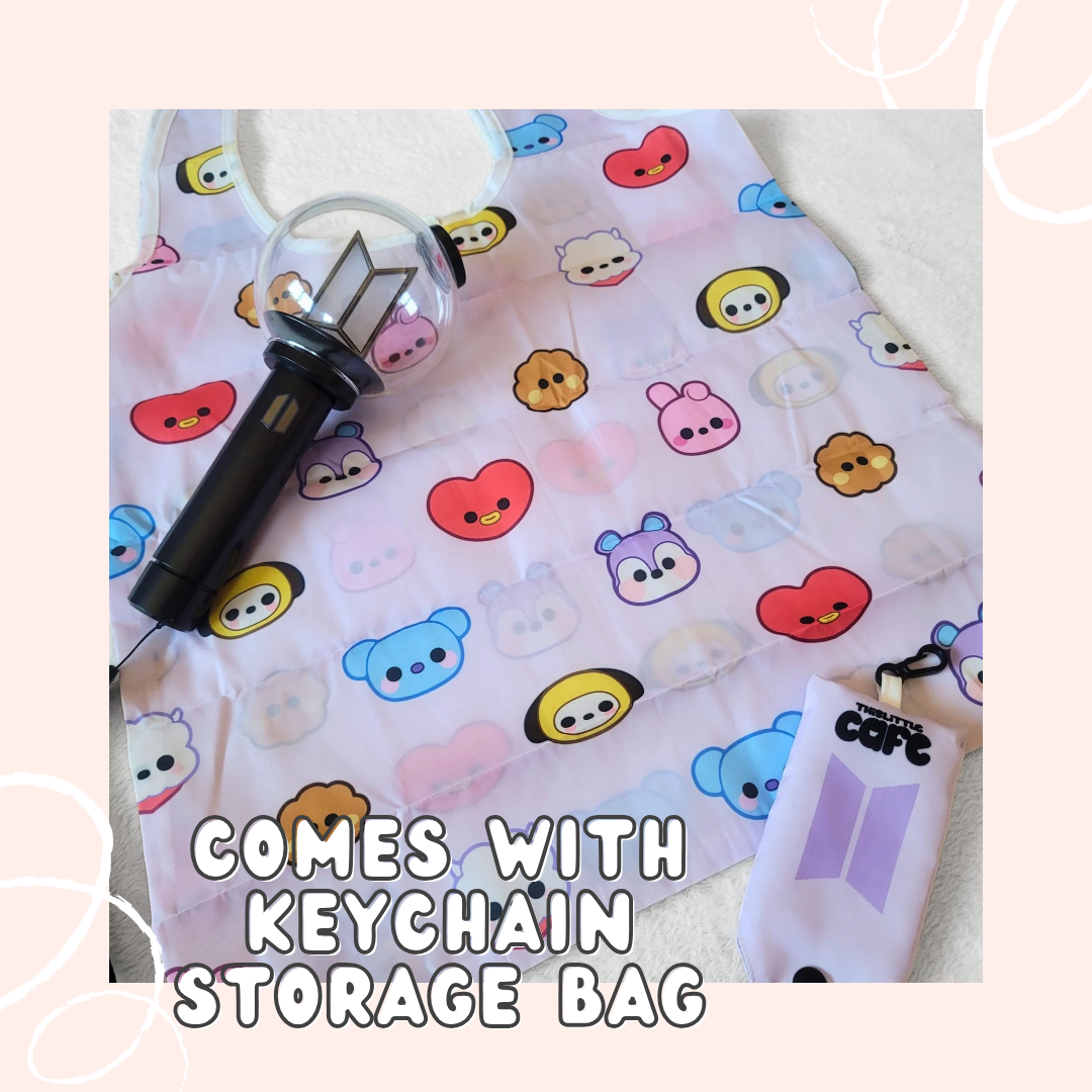 A light-purple tote bag with BTS's BT21 characters on a white background. A 5th generation bts lightstick is on the top-left side. The tote storage clip-on bag is on the bottom-right of the image. The words "COMES WITH KEYCHAIN STORAGE BAG" in white font are at the bottom with a light-pink background.