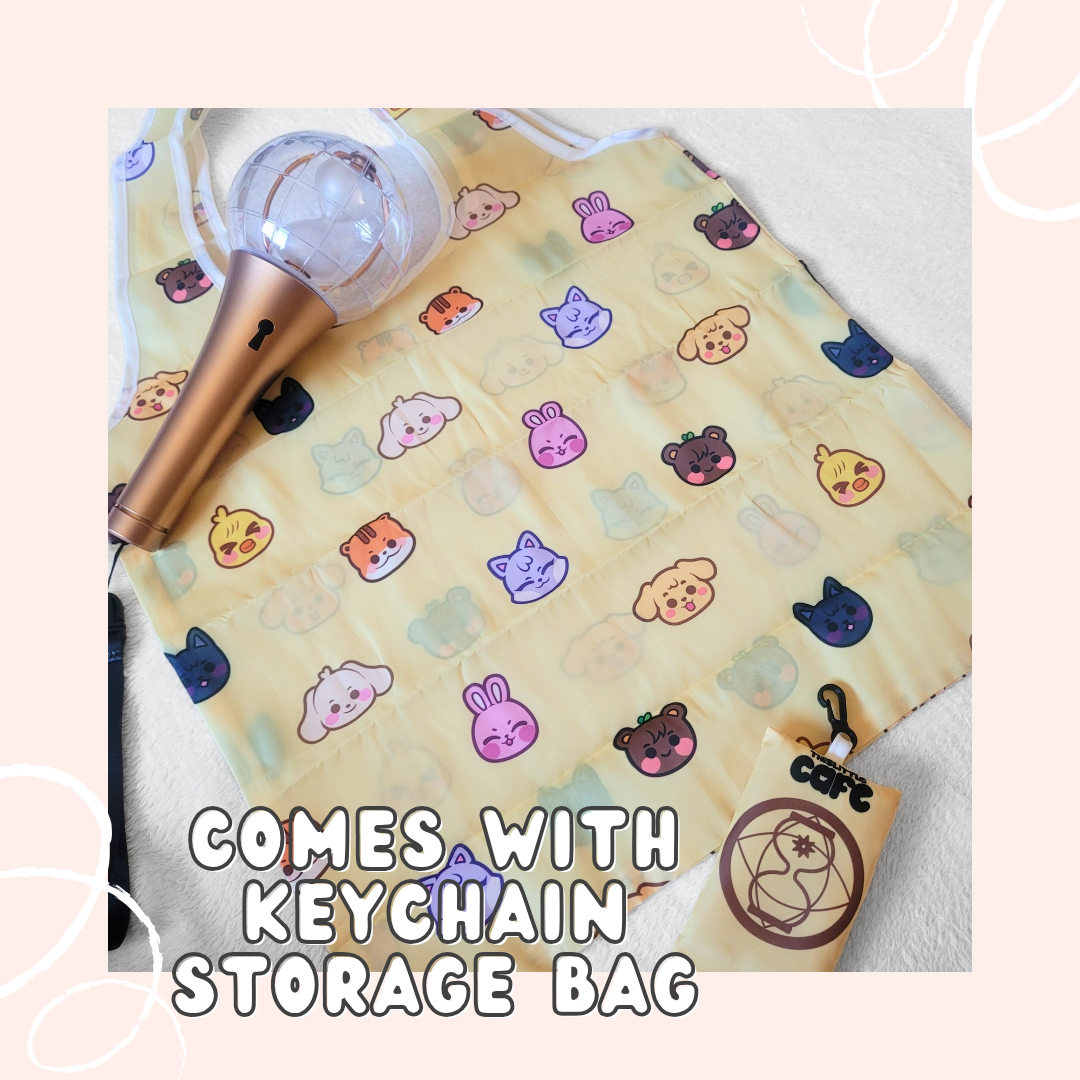 A yellow tote bag with Ateez's Aniteez characters on a white background. A 2nd generation ateez lightstick is on the top-left side. The tote storage clip-on bag is on the bottom-right of the image. The words "COMES WITH KEYCHAIN STORAGE BAG" in white font are at the bottom with a light-pink background.