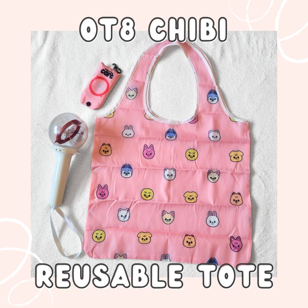 A pink tote bag with Stray Kids' Skzoo characters on a white background. A 1st generation stray kids lightstick is on the left side. The tote storage clip-on bag is on the top-left of the image. The text at the top of the image says "OT8 CHIBI" the text at the bottom says "REUSABLE TOTE" in white font on a light-pink background.